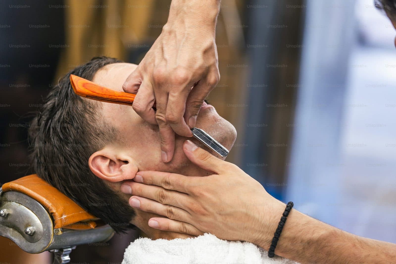 Straight razor shave in progress at the shop